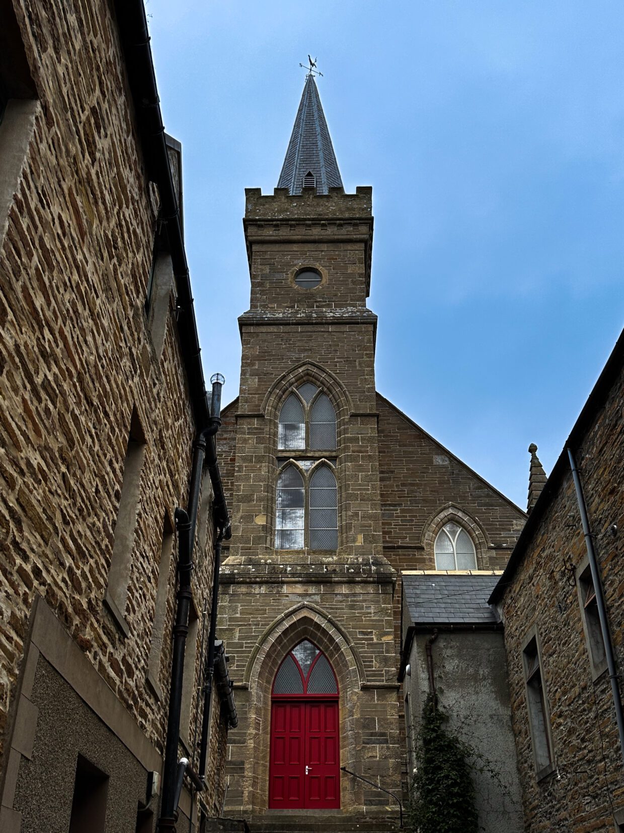 An old building, possibly a church, old stone and memories against a blue sky.